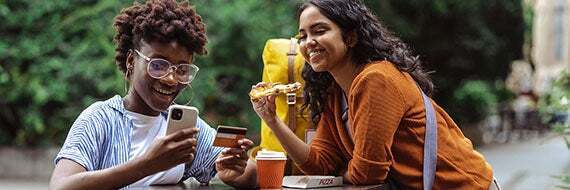 A student out with friends paying for something with a credit card